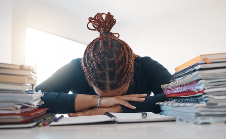 Stress, study and books with black woman sleeping at desk from burnout, tired or depression. Education, learning and knowledge with student rest at homework notebook with headache, anxiety or mistake