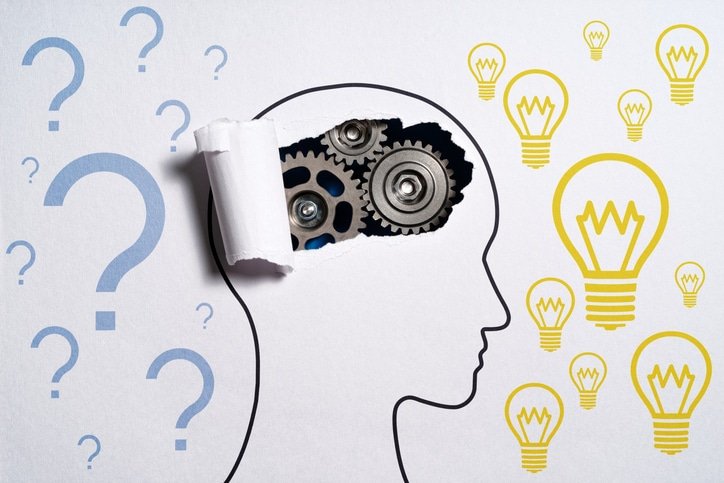 Thinking about questions and getting ideas. Human head silhouette and gears.